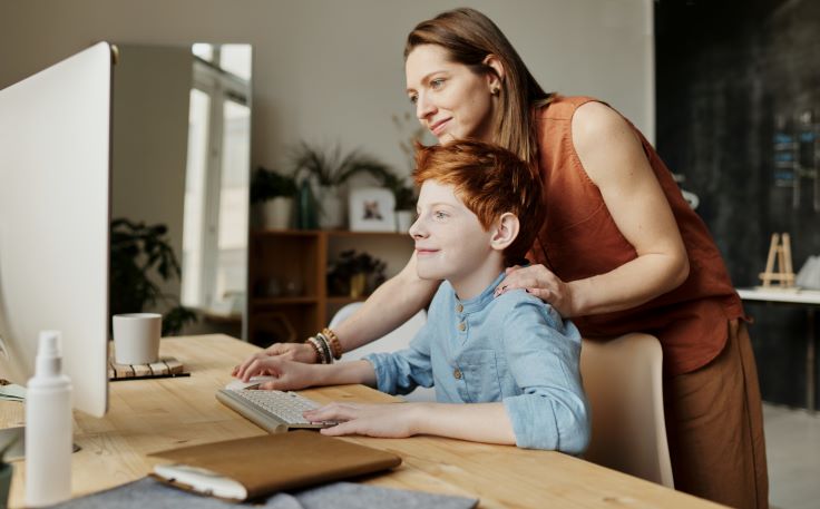 Mother and son looking at information on dyslexia on a computer